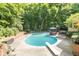 A refreshing in-ground pool with diving board surrounded by lush greenery for privacy at 10518 Courageous Dr, Indianapolis, IN 46236