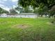 Spacious backyard with lush green grass, featuring a back door entry to the house at 115 Hugo St, Indianapolis, IN 46229