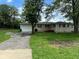 Charming single-story home with a one-car garage, set back from the street with lawn at 115 Hugo St, Indianapolis, IN 46229