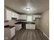 Kitchen featuring white cabinets, dark countertops, and new floors at 115 Hugo St, Indianapolis, IN 46229