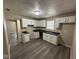 Kitchen featuring white cabinets, dark countertops, and new floors at 115 Hugo St, Indianapolis, IN 46229