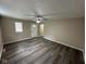 The living room features new gray vinyl plank flooring, neutral paint, and a ceiling fan at 115 Hugo St, Indianapolis, IN 46229