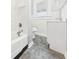 Bathroom featuring a classic white tub, toilet, vanity, and tiled floor at 1201 Arrow Ave, Anderson, IN 46016