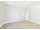Bedroom with neutral carpet, and white trim, with a closet and another room beyond at 1201 Arrow Ave, Anderson, IN 46016