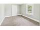 Cozy bedroom with neutral carpet, gray walls, and a window at 1201 Arrow Ave, Anderson, IN 46016