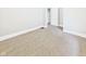 Spacious bedroom featuring neutral carpet, white trim, and a door to another room at 1201 Arrow Ave, Anderson, IN 46016