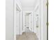 Hallway featuring neutral carpet, leading to multiple rooms, and lots of white trim at 1201 Arrow Ave, Anderson, IN 46016