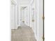 Hallway featuring neutral carpet, leading to multiple rooms, and lots of white trim at 1201 Arrow Ave, Anderson, IN 46016