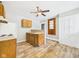 Functional kitchen featuring wood cabinets, laminate countertops, and vinyl flooring at 1201 Arrow Ave, Anderson, IN 46016