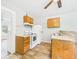 Modest kitchen featuring a white refrigerator, white electric range, and wood cabinets at 1201 Arrow Ave, Anderson, IN 46016