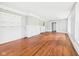Spacious living room with hardwood floors, white painted fireplace, and neutral gray walls at 1201 Arrow Ave, Anderson, IN 46016