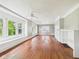 Spacious living room with hardwood floors, large windows, and ceiling fan at 1201 Arrow Ave, Anderson, IN 46016