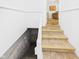 Stairwell with neutral carpet and white trim, leading down to the basement and up to the kitchen at 1201 Arrow Ave, Anderson, IN 46016