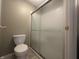 This bathroom features a toilet next to a shower with a frosted glass enclosure at 1289 Woodcreek Dr, Greenwood, IN 46142