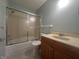 Bathroom features a vanity with a sink, toilet, and a shower with glass doors at 1289 Woodcreek Dr, Greenwood, IN 46142