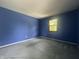 Bright bedroom with wall-to-wall carpeting and large window allowing for natural light at 1289 Woodcreek Dr, Greenwood, IN 46142