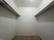 Walk-in closet with carpet flooring and shelving racks perfect for storage at 1289 Woodcreek Dr, Greenwood, IN 46142