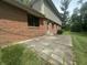 A cozy outdoor patio complements this brick home with a well-maintained lawn at 1289 Woodcreek Dr, Greenwood, IN 46142