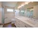 Bright bathroom features a double sink vanity, soaking tub, and separate glass enclosed shower at 13074 Lansdowne Dr, Fishers, IN 46038