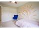 Bedroom featuring a rainbow mural, a rocking chair, and a closet at 13074 Lansdowne Dr, Fishers, IN 46038