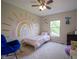Charming bedroom has a rainbow mural, rocking chair, and a single bed at 13074 Lansdowne Dr, Fishers, IN 46038