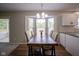 Bright dining area with a rustic wood table, bay window, and modern chandelier at 13074 Lansdowne Dr, Fishers, IN 46038