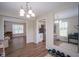 Well lit dining room showcasing mirror wall and views into adjacent kitchen and living areas at 13074 Lansdowne Dr, Fishers, IN 46038