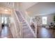 Bright entryway with staircase featuring white railing and plush carpet at 13074 Lansdowne Dr, Fishers, IN 46038