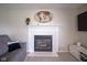Close up of an elegant fireplace with white mantel and decorative wall art at 13074 Lansdowne Dr, Fishers, IN 46038