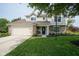 Charming two-story home with a well-manicured lawn, brick accents, and attached two-car garage at 13074 Lansdowne Dr, Fishers, IN 46038