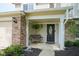 Charming front porch with brick accents, bench seating, and stylish entry door at 13074 Lansdowne Dr, Fishers, IN 46038