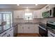 Well-lit kitchen with stainless appliances, white cabinets, subway tile backsplash, and granite countertops at 13074 Lansdowne Dr, Fishers, IN 46038