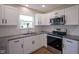 Updated kitchen featuring white cabinets, stainless steel appliances, and granite countertops at 13074 Lansdowne Dr, Fishers, IN 46038