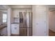 Bright kitchen area featuring stainless steel refrigerator, white cabinets, and updated flooring and countertops at 13074 Lansdowne Dr, Fishers, IN 46038
