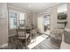 The dining area is bright with large windows, a patio door, and a modern farmhouse table at 13301 Minden Dr, Fishers, IN 46037