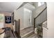 Inviting foyer featuring a staircase with wood and metal railing, stylish decor, and a view of the front door at 13301 Minden Dr, Fishers, IN 46037