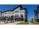 Modern townhouse complex featuring gray siding, private balconies, and well-maintained landscaping at 13301 Minden Dr, Fishers, IN 46037