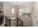 Hallway showcasing a modern chandelier, staircase with metal railings, and natural light from nearby windows at 13301 Minden Dr, Fishers, IN 46037