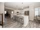 The island kitchen is spacious with white cabinets, stainless appliances, and breakfast seating at 13301 Minden Dr, Fishers, IN 46037