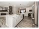 Open-concept kitchen with large island, white cabinets, stainless appliances, and gray flooring at 13301 Minden Dr, Fishers, IN 46037