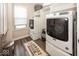 Bright laundry room features modern washer and dryer, storage shelves and gray wood-look flooring at 13301 Minden Dr, Fishers, IN 46037