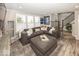 Comfortable living room featuring a plush sectional sofa, large windows with shutters, and stylish decor at 13301 Minden Dr, Fishers, IN 46037