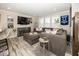 Comfortable living room featuring a plush sectional sofa, large windows with shutters, and stylish decor at 13301 Minden Dr, Fishers, IN 46037