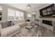 The living room features a modern fireplace, large TV, neutral decor, and plantation shutters at 13301 Minden Dr, Fishers, IN 46037