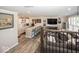 Open living space featuring a wet bar with white cabinets and seating next to a comfortable living room setup at 13301 Minden Dr, Fishers, IN 46037