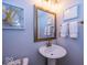 The half bathroom features luxury art and a pedestal sink with a gold faucet at 13301 Minden Dr, Fishers, IN 46037