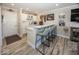 Stylish wet bar featuring white cabinets, a countertop bar with seating, and modern decor accents at 13301 Minden Dr, Fishers, IN 46037