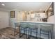 Stylish wet bar featuring white cabinets, a countertop bar with seating, and modern decor accents at 13301 Minden Dr, Fishers, IN 46037
