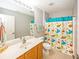Bathroom with single sink vanity and playful shower curtain at 14052 Rayners Ln, Fishers, IN 46037