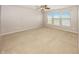 Spacious bedroom with a ceiling fan, ample natural light, and plush carpeting at 14052 Rayners Ln, Fishers, IN 46037